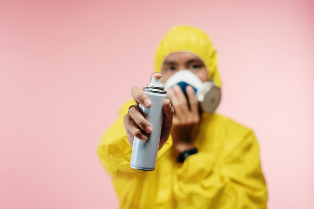 a person holding a pesticide spray