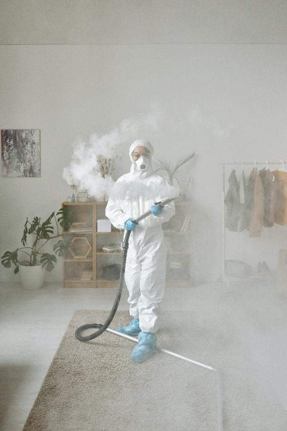 a pest control expert fumigating in a hazmat suit