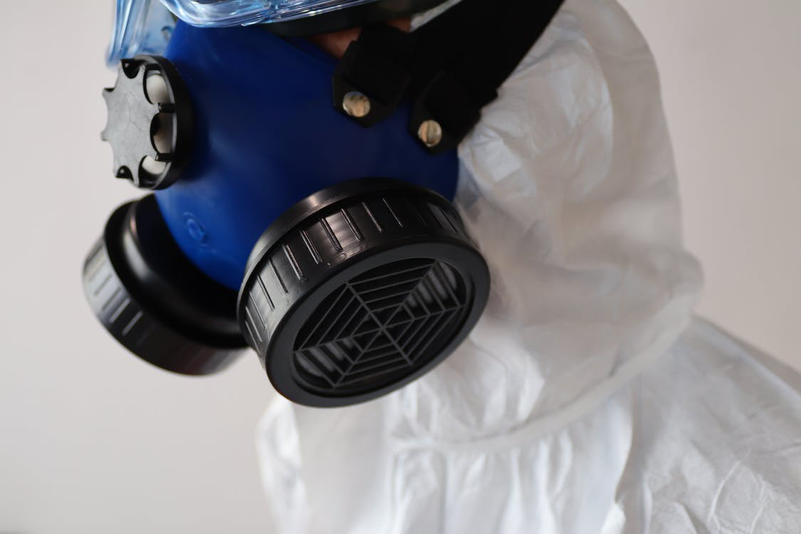 An image of a person wearing a mask over protective suit 