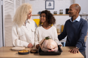 A family preparing Thanksgiving dinner in a bright, clean kitchen.